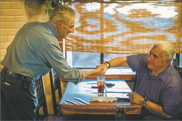  ?? NATHAN BURTON/Taos News ?? Pete Valdez, owner of Casa de Valdez, left, greets Dave Romero, owner of the Taos Historic Trolley and frequent customer on Monday (Nov. 15) in Taos. ‘It’s like coming home for dinner’, said Romero of the restaurant he’s been dining at for over six years. After serving the community for decades, Casa Valdez closed its doors on Tuesday (Nov. 23).