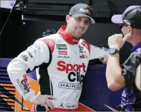  ?? TERRY RENNA — THE ASSOCIATED PRESS ?? Denny Hamlin talks with a crew member on pit road before winning the pole for Sunday’s NASCAR Cup Series auto race at Darlington Raceway, Saturday in Darlington, S.C.