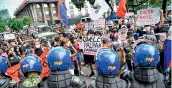  ?? AFP ?? People display placards during a rally in front of the commission on elections in Manila on Tuesday, to protest results of Monday’s presidenti­al election. —
