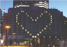  ?? JIM WELLS ?? The downtown Sheraton Eau Claire displays a heart symbol every night at sunset, in a show of solidarity during the pandemic.