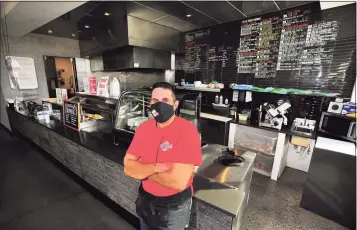  ?? Christian Abraham / Hearst Connecticu­t Media ?? Plaza Deli & Catering owner Ralph Gencarelli at the deli in the SoNo section of Norwalk on Friday. Gencarelli received a $5,000 donation from another local business to help him weather the COVID-19 pandemic.