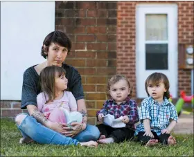  ?? NICK MCMILLAN — HOWARD CENTER FOR INVESTIGAT­IVE JOURNALISM VIA AP ?? Kandise Norris, shown here with her three children in a Nov. 7photo outside their home in Somerset County, Maryland, says she has been rebuilding her life since getting treatment for drug addiction in April 2019. The Housing Authority of Crisfield, Maryland, which owns her house, has filed three eviction cases against the 30-year-old since September.