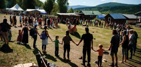  ??  ?? People encircle a sacred canoe at the 2018 Moosehide Gathering, a biennial celebratio­n of Tr’ondëk Hwëch’in cultural traditions that takes place at the Moosehide Village heritage site downriver from Dawson City, Yukon.