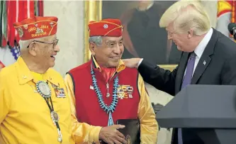  ?? OLIVER CONTRERAS/GETTY IMAGES ?? U.S. President Donald Trump greets members of the Native American Code Talkers during an event in the Oval Office of the White House on Monday.