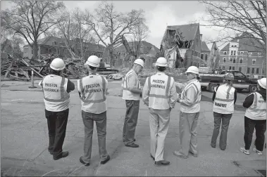  ??  ?? Above, On March 22, 2012, demolition crews from Manafort tear down the Salmon Building on the former Norwich State Hospital property in Preston.