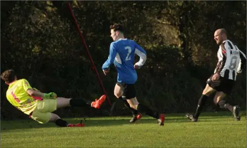  ??  ?? John Staples (right) of Corach Ramblers scores in the FAI Junior Cup fourth round tie against Courtown Hibs.