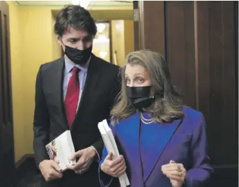  ?? SEAN KILPATRICK/THE CANADIAN PRESS VIA AP ?? Canada’s Finance Minister Chrystia Freeland and Prime Minister Justin Trudeau speak with the media before the release of the federal budget in Ottawa on Thursday.