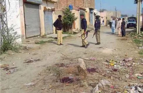  ??  ?? ANGGOTA polis berkawal di sebatang jalan di kampung Garahmat, Dera Ismail Khan di Pakistan. - AFP