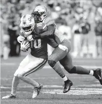  ?? JOHN RAOUX/AP ?? Vanderbilt safety Tae Daley, right, tackles Florida wide receiver Josh Hammond (10) after a reception during the first half Nov. 9, 2019, in Gainesvill­e, Fla.