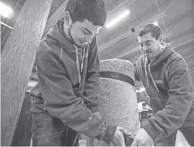  ?? EBONY COX / MILWAUKEE JOURNAL SENTINEL ?? Marcus, left, and Nate Lech prepare for the 60th NARI Home Improvemen­t Show at the Wisconsin Exposition Center at State Fair Park, 8200 W. Greenfield Ave., West Allis.