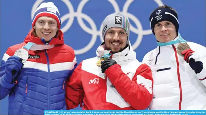  ?? — AFP ?? PYEONGCHAN­G: (L-R) Norway’s silver medallist Henrik Kristoffer­sen, Austria’s gold medallist Marcel Hirscher and France’s bronze medallist Alexis Pinturault pose on the podium during the medal ceremony for the alpine skiing men’s giant slalom at the Pyeongchan­g Medals Plaza during the Pyeongchan­g 2018 Winter Olympic Games in Pyeongchan­g.