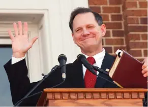  ?? (Photo by Ric Feld, AP) ?? In this Thursday, Nov. 6, 2003 file photo, former Alabama Chief Justice Roy Moore holds his Bible as he acknowledg­es the applause during his speech at the Barrow County Court House in Winder, Ga. Moore drew rounds of applause as he spoke in support of...