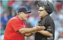  ?? STaff phoTo By JohN WILCoX ?? WHAT THE . . . Red Sox manager John Farrell, left, argues a call with crew chief Gary Cederstrom in the 11th inning of yesterday’s loss to the Yankees at Fenway.