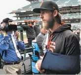  ?? Carlos Avila Gonzalez / The Chronicle ?? Madison Bumgarner, his throwing arm in a sling, faced questions over his dirt-bike accident.