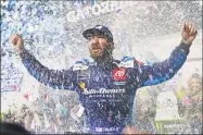  ?? Steve Helber / Associated Press ?? Martin Truex Jr. celebrates after winning the Monster Energy NASCAR Cup Series First Data 500 Sunday at Martinsvil­le Speedway in Martinsvil­le, Va.