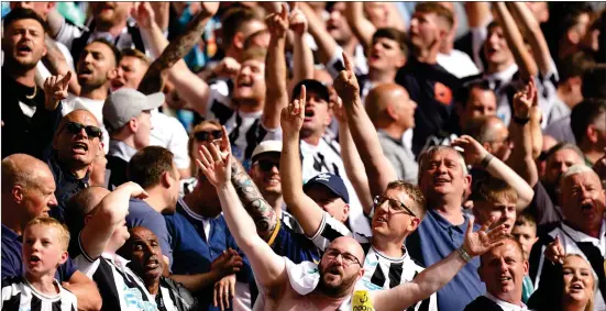  ?? ?? Newcastle United fans celebrate after Allan Saint-maxim (not pictured) scores his side’s first goal of the game during the Premier League match at the Molineux Stadium, Wolverhamp­ton. Photo: Jacob King/pa Wire.