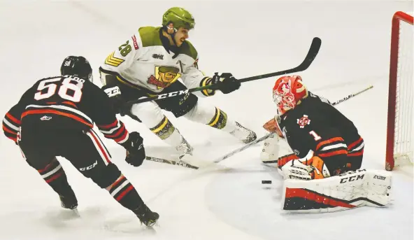  ?? SEAN RYAN ?? Luke Moncada of the North Bay Battalion tries to beat goaltender Tucker Tynan of the Niagara Icedogs in recent OHL action. Tynan’s leg was cut by a skate in a game Thursday.