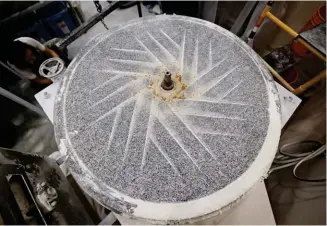  ?? ?? Above: Gabrielle Prud’homme, owner of Almanac Urban Mill and Bakery, uses a granite mill to grind whole grains. When the large machine recently required sharpening, she reached out to others in the industry for guidance