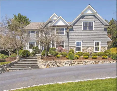  ?? Daniele Piovezahn / Contribute­d photo ?? This six-bedroom, five-and-a-half bath colonial at 6 Pleasant Valley Lane, Westport, spans over 7,000 square feet on four levels, set on a majestic, landscaped acre with flowering trees, stone pathways, an enchanting gazebo and grand patio.