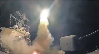  ?? MASS COMMUNICAT­ION SPC. 3RD CLASS FORD WILLIAMS, U. S. NAVY, VIA AP ?? The USS Porter fires a Tomahawk missile from theMediter­ranean Sea. The United States blasted a Syrian air base with cruise missiles in response to a chemical attack against civilians.