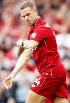  ??  ?? Liverpool’s Jordan Henderson puts on the captain’s armband after coming on as a substitute during the English Premier League match against West Ham United at Anfield in Liverpool, Britain in this Aug 12 file photo. — Reuters photo