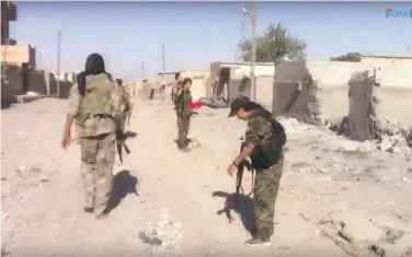  ?? Furat FM / Associated Press ?? U.S.-backed fighters patrol Raqqa, Syria, after their forces breached the wall around the Old City, marking a major advance in the battle to drive Islamic State militants out of their self-declared capital.