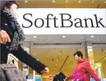  ?? Eugene Hoshiko Associated Press ?? THE JAPANESE tech giant SoftBank announced a $100-million Opportunit­y Fund in early June to invest exclusivel­y in entreprene­urs of color. Above, people pass a SoftBank store in Tokyo’s Ginza shopping district.