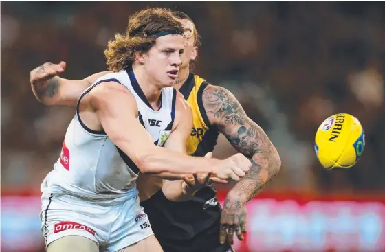  ??  ?? Nat Fyfe of the Dockers and Tigers star Dustin Martin could renew old rivalries when the two clubs meet this Sunday. Picture: GETTY IMAGES