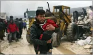  ?? GHAITH ALSAYED — THE ASSOCIATED PRESS ?? A man carries the body of an earthquake victim in the Besnia village near the Turkish border, Idlib province, Syria, Monday.