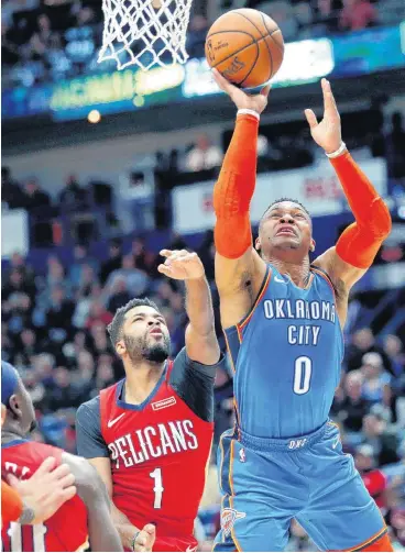  ?? [AP PHOTO] ?? Oklahoma City Thunder guard Russell Westbrook goes to the basket Wednesday against New Orleans Pelicans guard Andrew Harrison and forward Julius Randle in New Orleans.