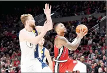  ??  ?? Portland Trail Blazers guard Damian Lillard (right), drives to the basket on Indiana Pacers forward Domantas Sabonis (left), during the second half of an NBA basketball game in Portland, Ore on Jan 26. Lillard scored 50
points as the Blazers won 139-129. (AP)