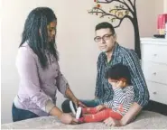  ?? TRISTAN SPINSKI/THE NEW YORK TIMES ?? Leandro Arriaga, who came to the U.S. in 2001 illegally, sits in his home in Lawrence, Mass., with his wife, Katherine, and 15-month-old daughter, Jade. After an immigratio­n officer certified his marriage in March 2017, clearing him to move to the next...