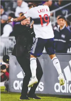  ??  ?? Whitecaps coach Marc Dos Santos celebrates what the team thought was a Vancouver goal with Lass Bangoura Friday. The goal was overturned because of an offside.