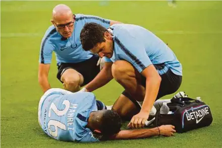  ?? AFP PIC ?? Medical staff attend to Riyad Mahrez after he was injured in the first half against Bayern Munich in the Internatio­nal Champions Cup on Saturday.