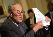  ?? WIN MCNAMEE / GETTY IMAGES ?? Senate Minority Leader Chuck Schumer (D-N.Y.) holds up a copy of a transcript provided by the Trump administra­tion of the phone call between President Donald Trump and Ukrainian President Volodymyr Zelenskiy.