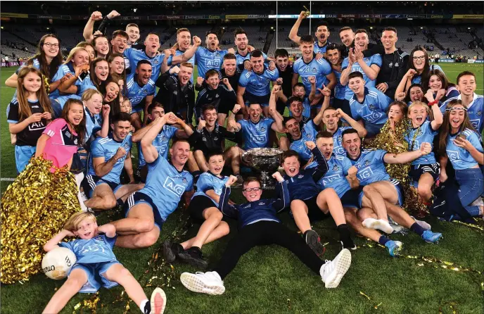  ??  ?? Dublin players and supporters celebrate with the Sam Magure Cup