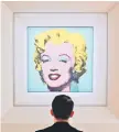  ?? — AFP file photo ?? A man looks at Andy Warhol’s ‘Shot Sage Blue Marilyn’ during Christie’s 20th and 21st Century Art press preview at Christie’s New York in New York City.