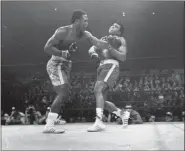  ?? UNCREDITED - STAFF, AP ?? Joe Frazier hits Muhammad Ali with a left during the
15th round of their heavyweigh­t title fight at New York’s Madison Square Garden, in this March 8, 1971, file photo. Frazier was a relentless puncher filled with rage toward a fighter who couldn’t help but belittle him.