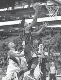  ?? PATRICK BREEN/THE REPUBLIC ?? Suns guard Elfrid Payton drives for a layup past Trail Blazers defender Damian Lillard on Saturday night.