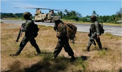  ?? ?? Filipino troopers walk beside a US CH-47 helicopter inside the Naval Base Camilo Osias in Santa Ana, Cagayan province, northern Philippine­s after participat­ing in joint military exercises on Monday, May 6, 2024. AP Photo