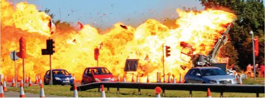  ?? ?? Fireball: The moment when Andrew Hill’s Hawker Hunter crashed onto a dual carriagewa­y in West Sussex, killing 11