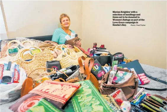  ?? Photo / Paul Taylor ?? Marian Keighley with a selection of handbags and items set to be donated to Women’s Refuge as part of the Love Grace campaign in Hawke’s Bay.