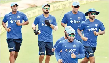  ??  ?? Captain MS Dhoni with teammates during the training session ahead of third T20 match against South Africa at the Eden Gardens in Kolkata on Wednesday.