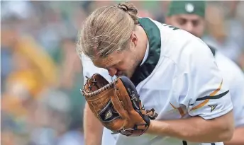  ?? RON PAGE / USA TODAY-WISCONSIN ?? Packers linebacker Clay Matthews is hit by a line drive while pitching during the Green & Gold Charity Softball Game on Saturday.