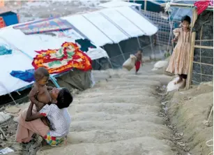  ?? (Mohammad Ponir Hossain/Reuters) ?? ROHINGYA REFUGEE children are seen in a makeshift refugee camp yesterday in Cox’s Bazar, Bangladesh.