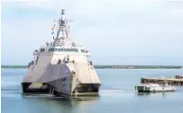  ?? MASS COMMUNICAT­ION SPECIALIST 1ST CLASS JOHN PHILIP WAGNER JR./U.S. NAVY VIA AP ?? A Naval Station vessel, right, prepares to assist the future USS Omaha (LCS 12), a 218-foot-long littoral combat ship, pier side during a brief fuel stop in Guantanamo Bay, Cuba. The Omaha was conducting a change of homeport to San Diego, Calif.