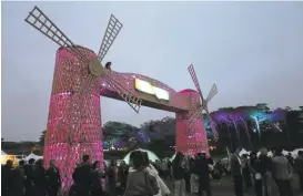  ?? RAY CHAVEZ/STAFF PHOTOS ?? The two windmills at the Polo Fields at Golden Gate Park are part of the Outside Lands’ ambience. The festival is the second-highest grossing event of its kind in the country.