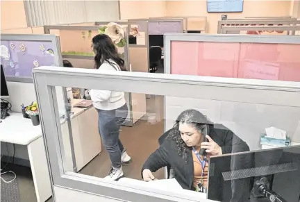  ?? ERIC PAUL ZAMORA ezamora@fresnobee.com ?? Suicide Prevention Specialist Luz Lopez, bottom right, answers a call at the 988 Suicide & Crises Lifeline call center April 26 in Fresno.