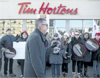  ?? CHRIS YOUNG/THE CANADIAN PRESS ?? President of Ontario Federation of Labour Chris Buckley addresses protesters outside a Tim Hortons in Toronto on Wednesday. Labour organizati­ons across Ontario held rallies on Wednesday to protest the actions some Tim Hortons franchises have taken in...