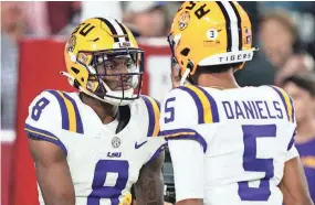  ?? JOHN DAVID MERCER/USA TODAY SPORTS ?? LSU’s Malik Nabers, left, celebrates his touchdown against Alabama with quarterbac­k Jayden Daniels last season.